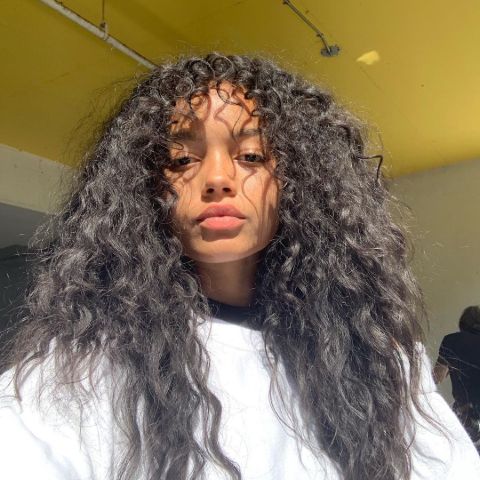 Whitney Peak in a white t-shirt poses for a picture in her Instagram.